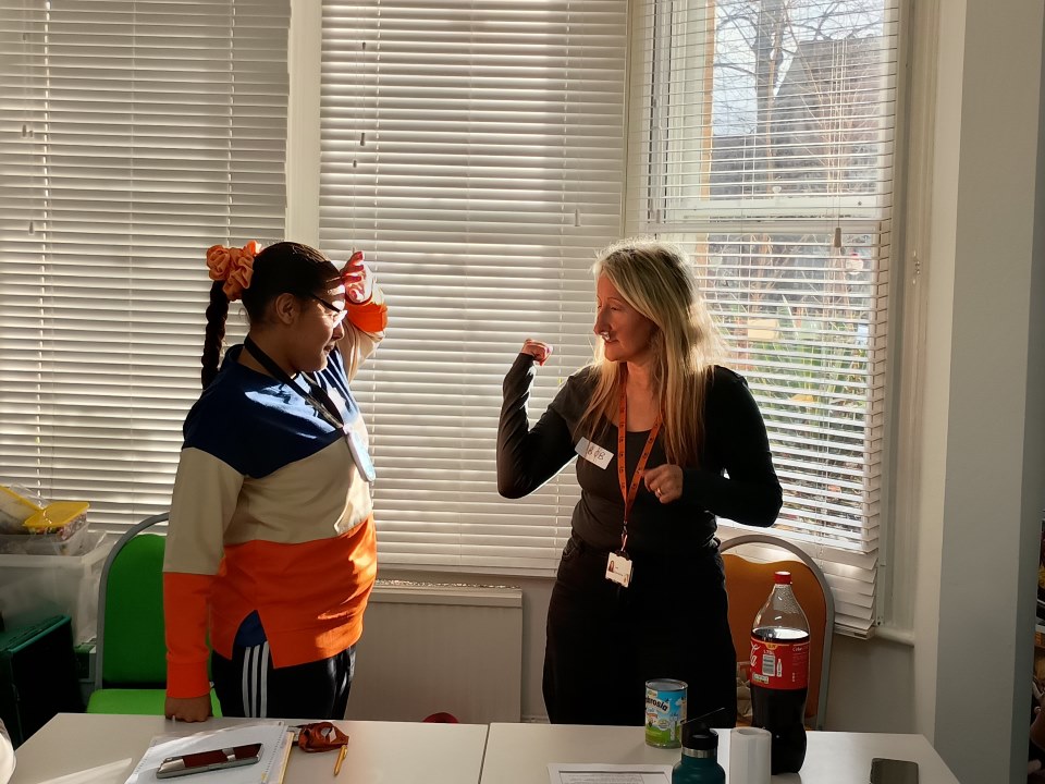 Nadeen working on developing her communication to ask for assistance with Julie, Habilitation Specialist.jpgv